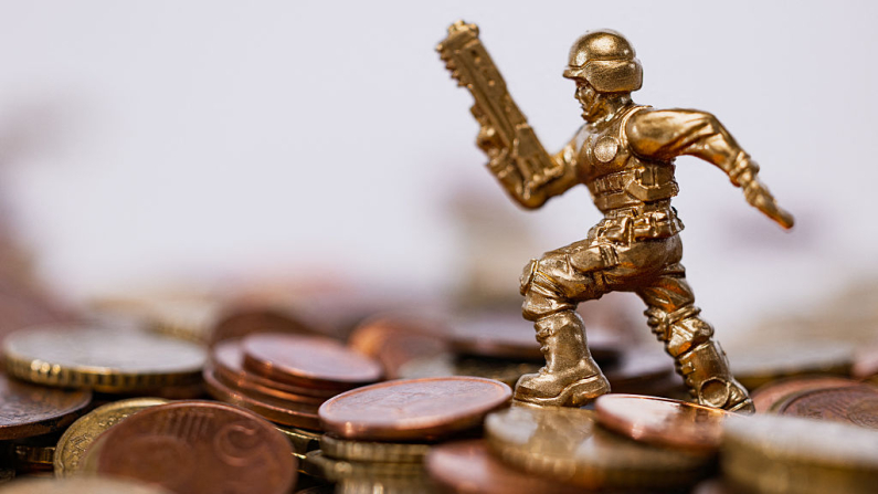 This illustration photograph shows a toy soldier among euro coins in Paris on July 11, 2025. (Photo by JOEL SAGET / AFP) (Photo by JOEL SAGET/AFP via Getty Images)